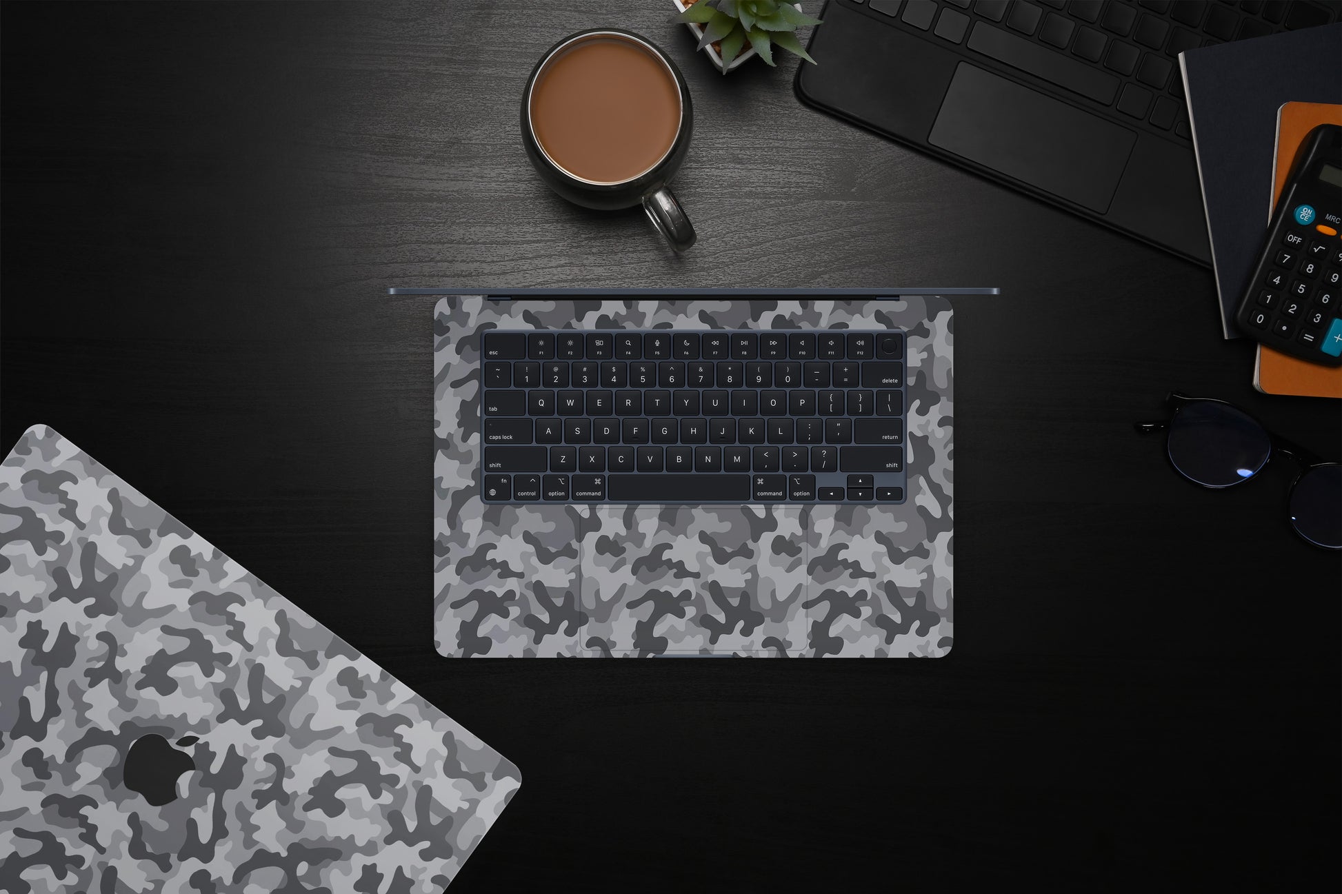 Close-up view of a Camo pattern MacBook skin sticker decal, featuring a classic camouflage design in shades of green, brown, and black