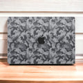 Close-up view of a Camo pattern MacBook skin sticker decal, featuring a classic camouflage design in shades of green, brown, and black