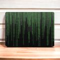 Close-up view of a Matrix design MacBook skin decal, featuring a sleek and intricate digital-inspired pattern with geometric shapes and lines.