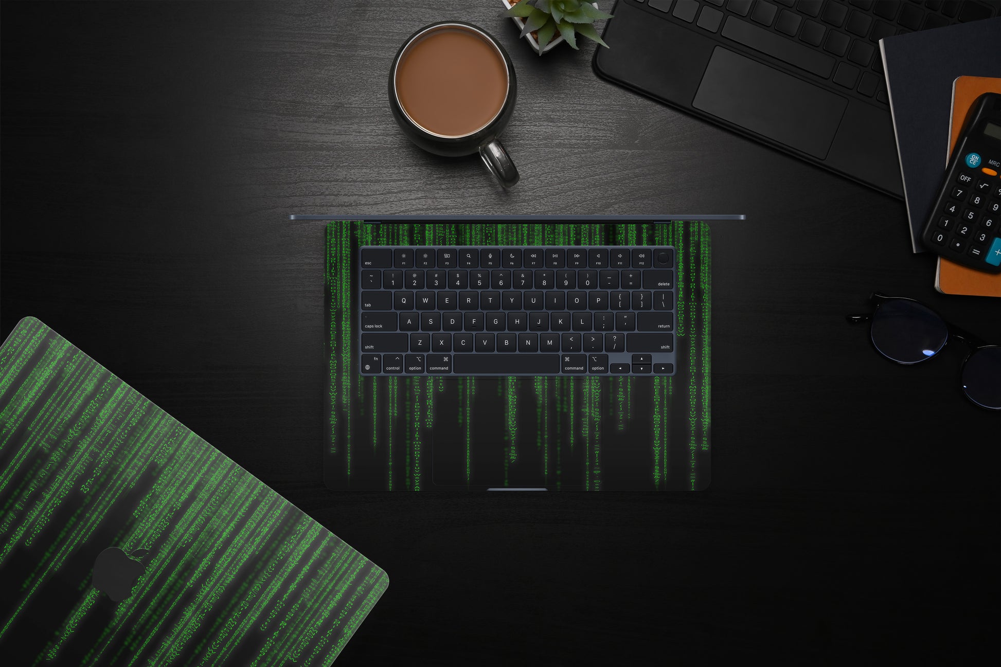 Close-up view of a Matrix design MacBook skin decal, featuring a sleek and intricate digital-inspired pattern with geometric shapes and lines.