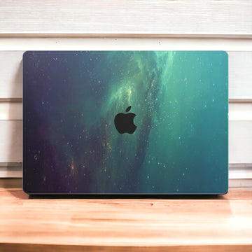 Close-up view of a Nebula Green Stars MacBook skin decal, featuring a vivid green nebula with shimmering stars scattered throughout, creating a celestial and enchanting scene.