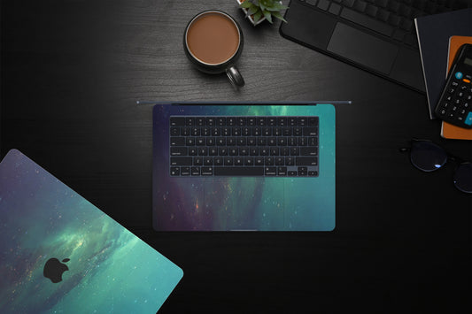 Close-up view of a Nebula Green Stars MacBook skin decal, featuring a vivid green nebula with shimmering stars scattered throughout, creating a celestial and enchanting scene.