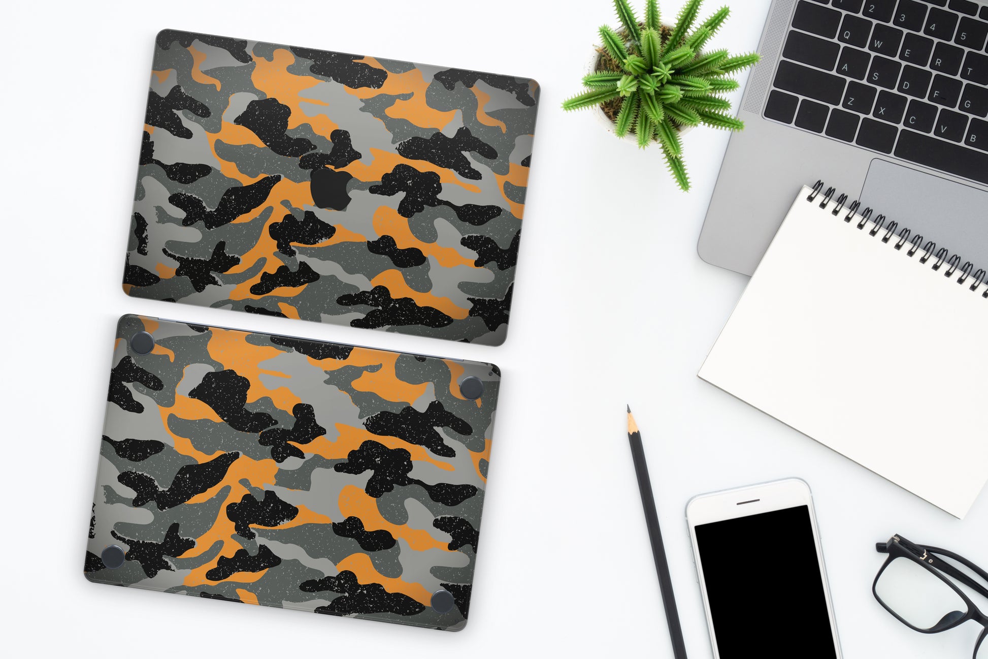 Close-up view of a Camo pattern MacBook skin sticker decal, featuring a classic camouflage design in shades of green, brown, and black